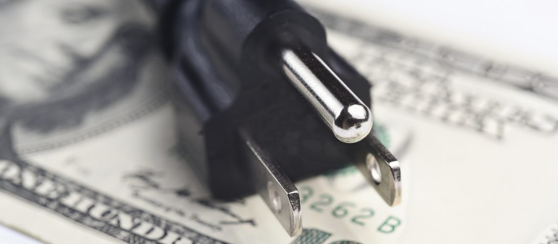 power cord over us dollar bills